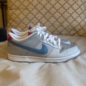 Nike Men’s Dunks — Light Gray with Blue Swoosh and Red Heel Accent